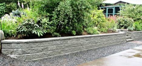 concrete block retaining wall that built to replace the previously damaged retaining wall