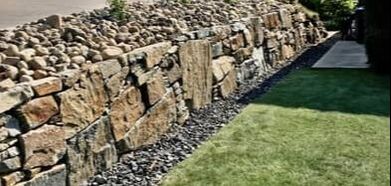 dry stone retaining wall next to a driveway